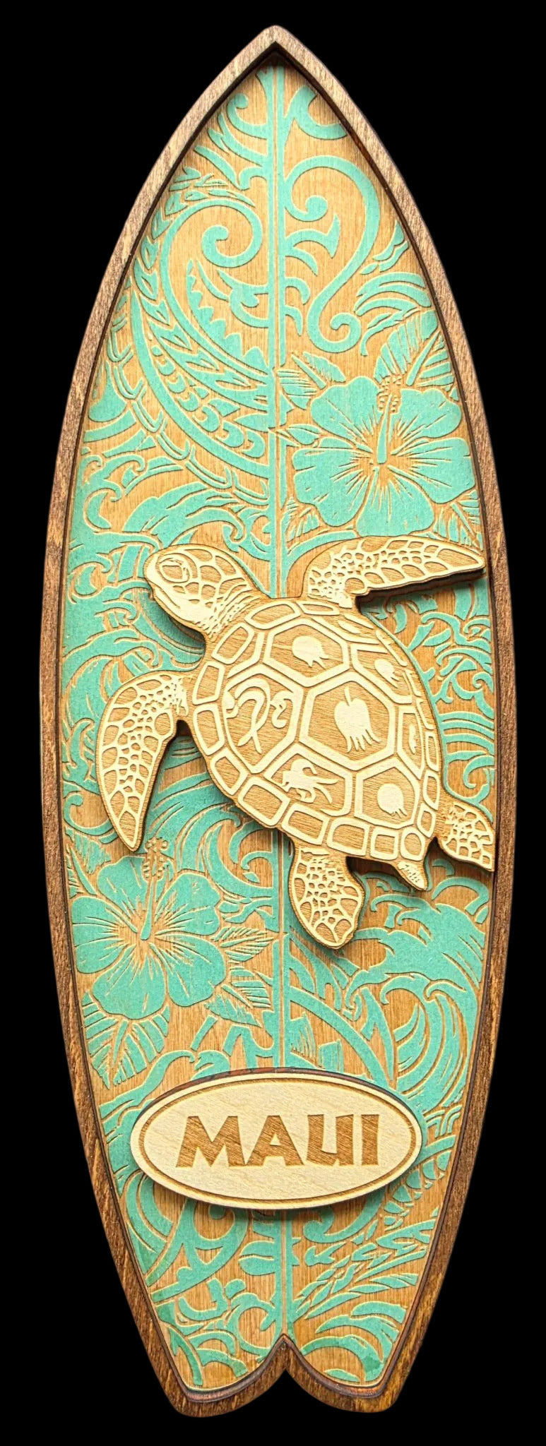 Decorative surfboard-shaped sign with a turtle design and 'Maui' text on a teal background.