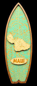 Decorative surfboard-shaped plaque with Maui map and text on a black background