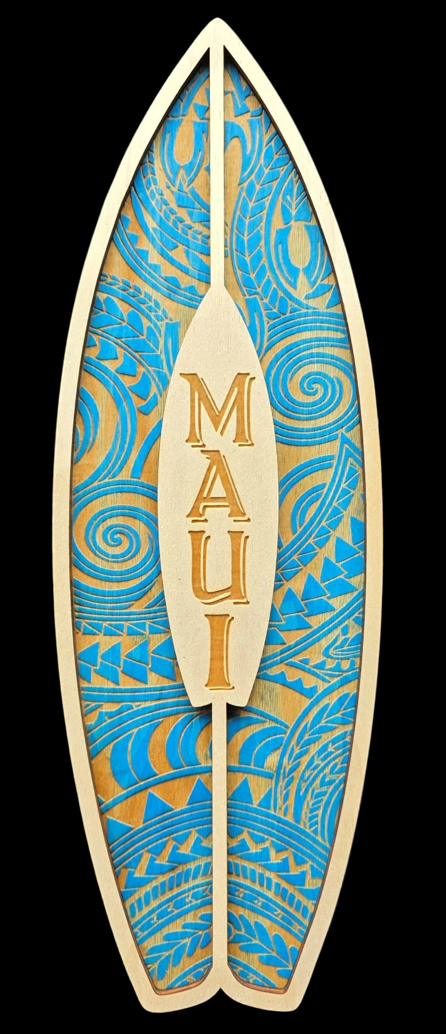 Decorative surfboard-shaped sign with blue and gold patterns and 'MAUI' text on a black background.