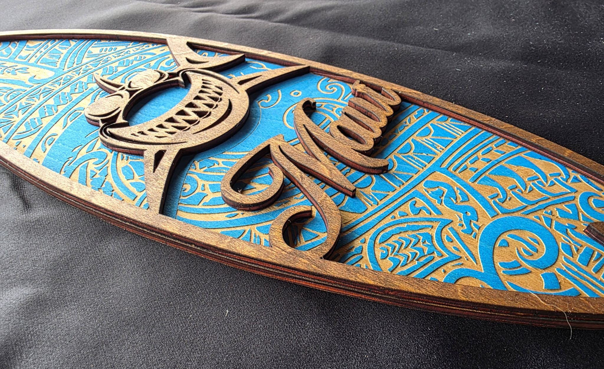 Wooden decorative item with intricate carvings on a blue background