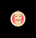 Medal with a tiki design and 'Maui' text on a gray background