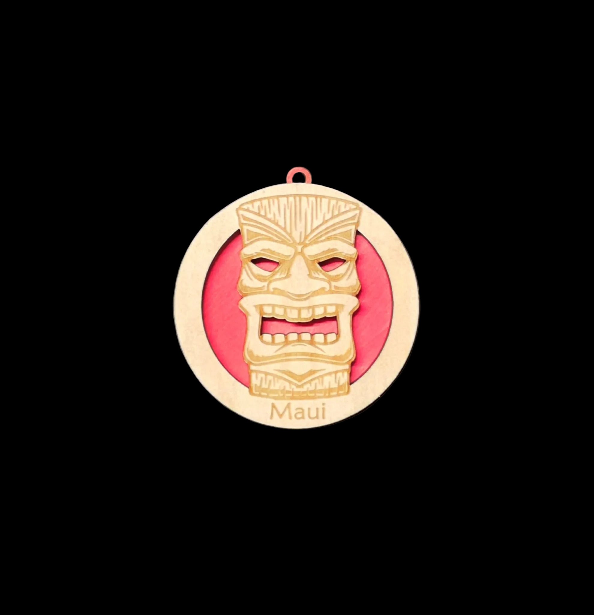 Medal with a tiki design and 'Maui' text on a gray background