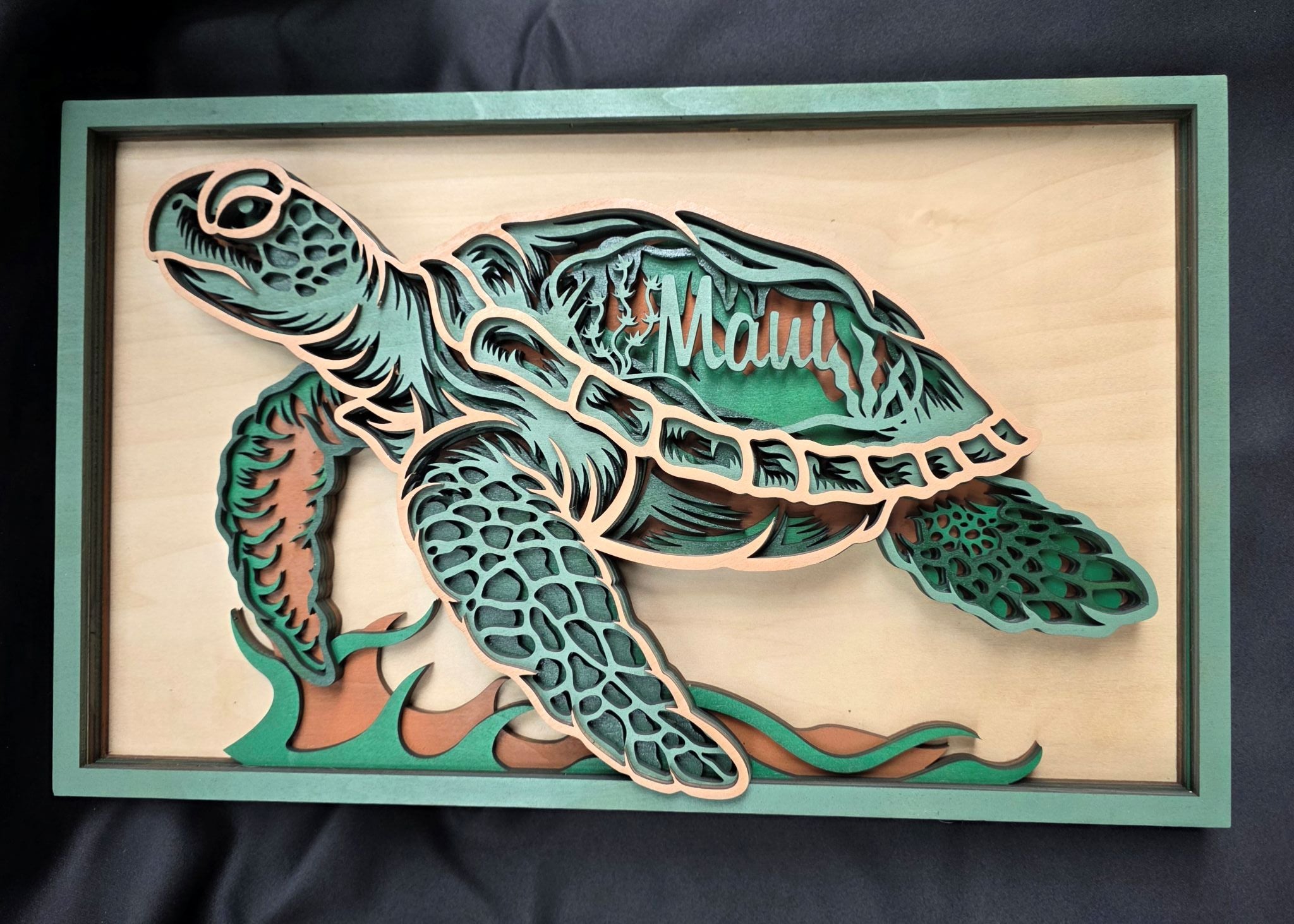 Wooden turtle sculpture with a green and brown color scheme on a dark background