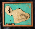 Wooden map of Maui with a teal background