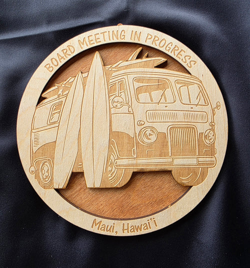 Wooden coaster with a laser-cut design of a van and surfboards, text 'Board Meeting in Progress' and 'Maui, Hawaii'.