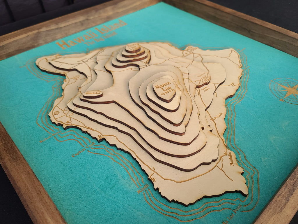 Wooden topographic map of Hawaii on a teal background