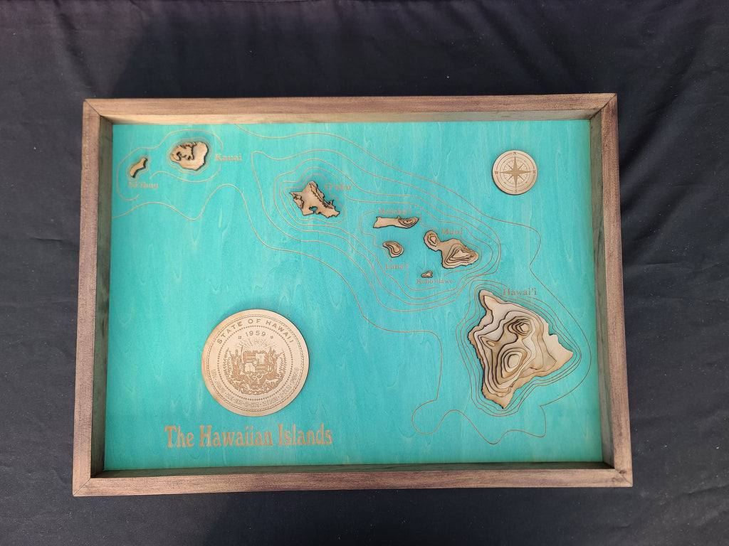 Map of The Hawaiian Islands with wooden frame and gold accents on a black background